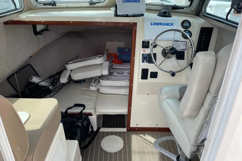 Slide: The Image of 2002 Parker 2520 XL Sport Cabin interior with steering wheel and navigation equipment. - 12