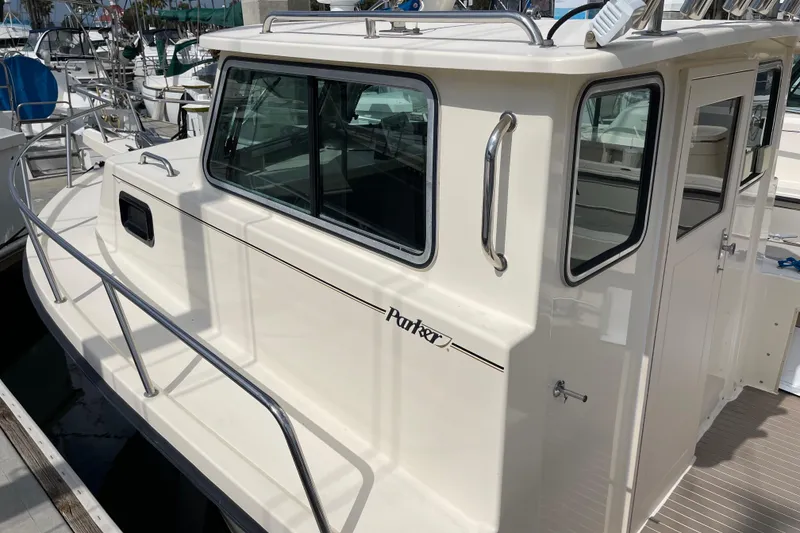 Slide: The Image of 2002 Parker 2520 XL Sport Cabin boat docked at marina. - 7
