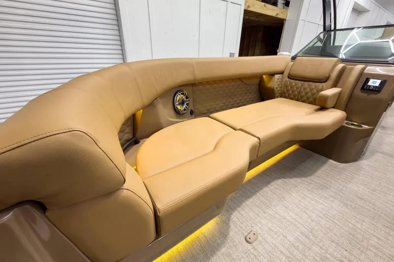 Slide: The Image of Luxurious tan seating in 2026 Godfrey Sanpan 27' Tritoon, featuring ambient lighting and modern design. - 15