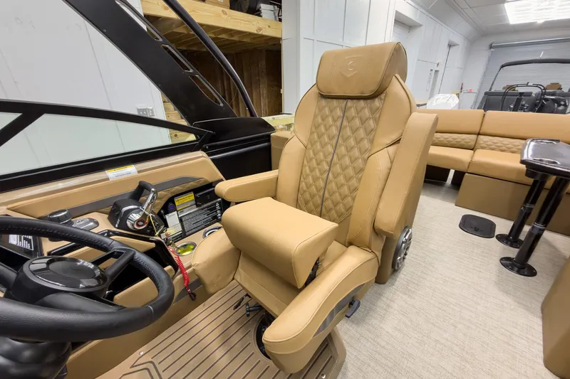Slide: The Image of Luxurious interior of 2026 Godfrey Sanpan 27' Tritoon with tan leather seating and modern controls. - 23