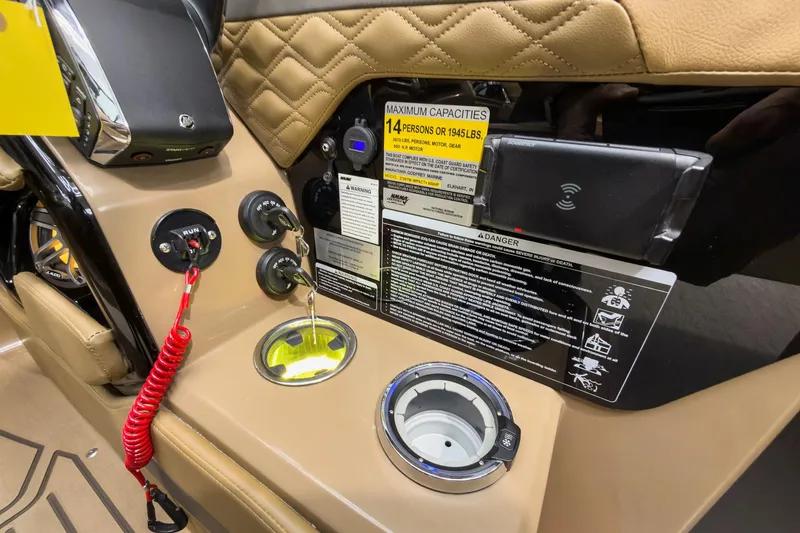 Slide: The Image of Control panel of 2026 Godfrey Sanpan 27' Tritoon with safety labels and ignition switches. - 27