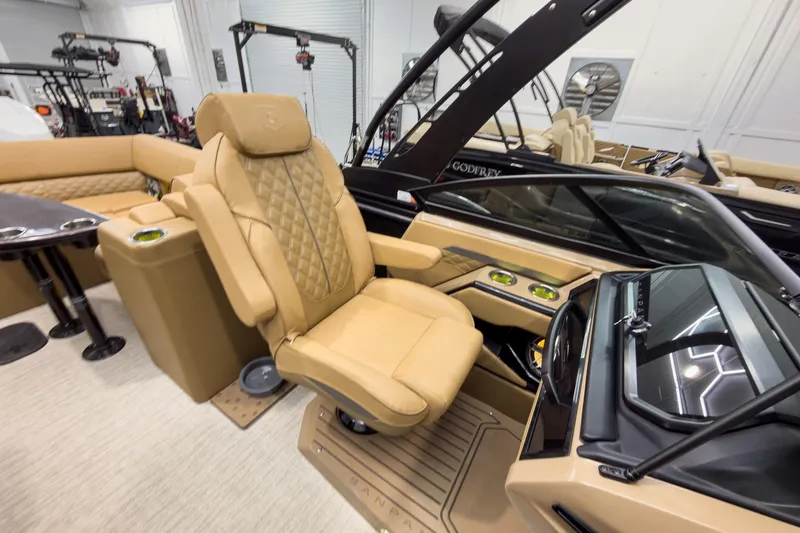 Slide: The Image of Luxurious interior of 2026 Godfrey Sanpan 27' Tritoon with plush seating and modern dashboard. - 32