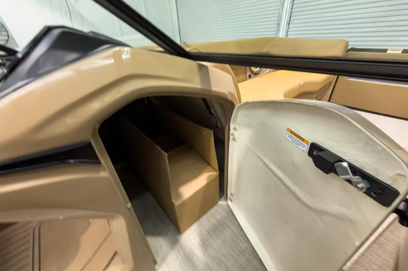 Slide: The Image of 2026 Godfrey Sanpan 27' Tritoon interior storage compartment with open door. - 34