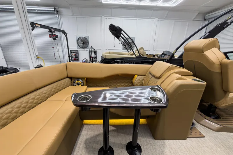 Slide: The Image of Luxurious interior of 2026 Godfrey Sanpan 27' Tritoon with tan seating and sleek table. - 37
