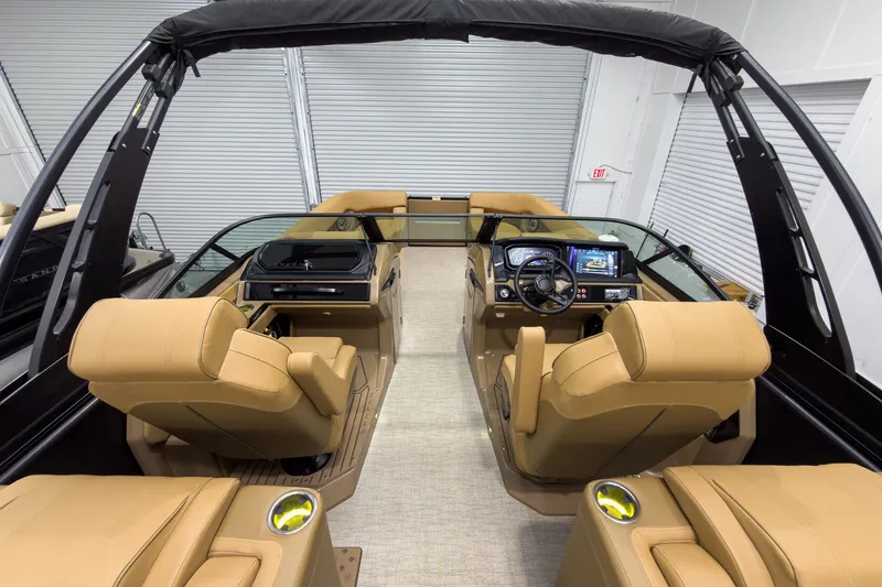 Slide: The Image of Luxurious interior of 2026 Godfrey Sanpan 27' Tritoon with tan seating and modern dashboard. - 46