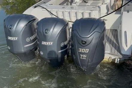 The Image of Triple Yamaha F300 outboard motors on a boat, 2020 model, in water. - 1