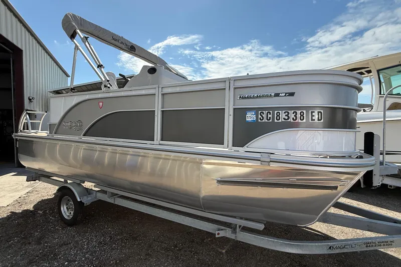 The Image of 2023 G3 BOATS Select 18f pontoon boat on trailer, parked outside a building. - 0