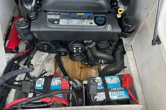 Slide: The Image of Engine compartment of a 2016 Sea Ray 220 Sundeck with visible batteries and wiring. - 11