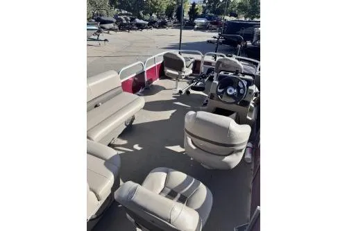 Slide: The Image of 2022 Sun Tracker Bass Buggy 18 DLX pontoon boat interior with seating and steering console. - 3