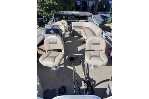 Slide: The Image of 2022 Sun Tracker Bass Buggy 18 DLX interior with beige seating and fishing gear. - 5