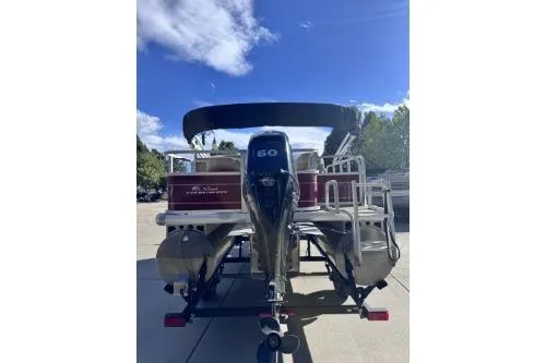 Slide: The Image of 2022 Sun Tracker Bass Buggy 18 DLX pontoon boat with 60 HP engine, parked outdoors. - 6