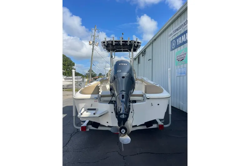 Slide: The Image of 2014 Pioneer 197 Islander boat with Yamaha outboard motor, parked outside dealership. - 12