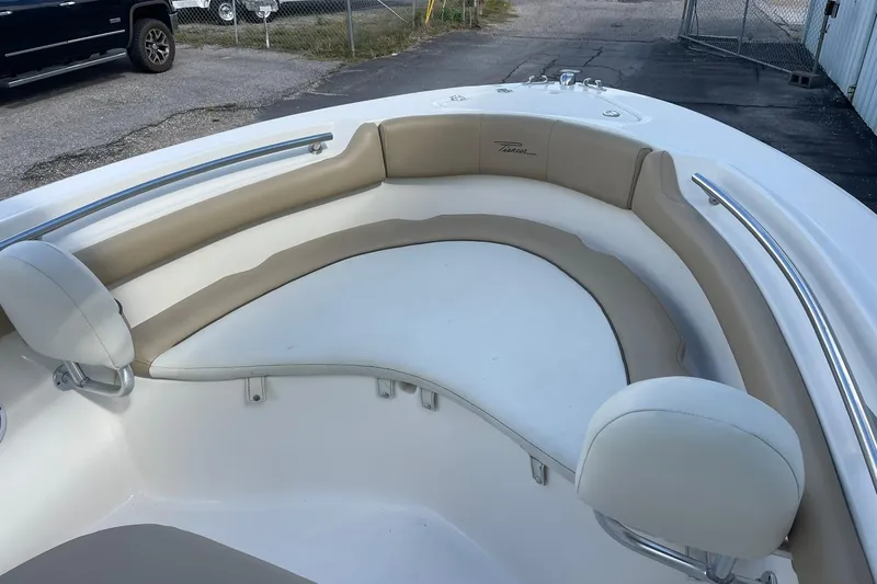 Slide: The Image of 2014 Pioneer 197 Islander boat with beige seating and stainless steel railings. - 14