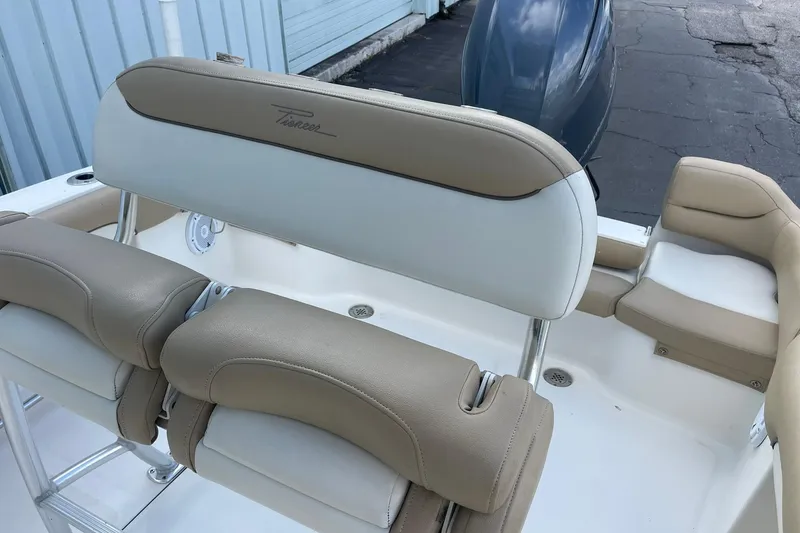 Slide: The Image of 2014 Pioneer 197 Islander boat interior with beige seating and backrest. - 18