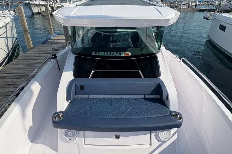 Slide: The Image of 2025 Axopar 29 XC Cross Cabin boat docked at marina, featuring sleek design and comfortable seating. - 14