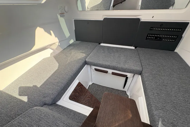 Slide: The Image of 2025 Axopar 29 XC Cross Cabin interior with gray seating and control panel. - 21