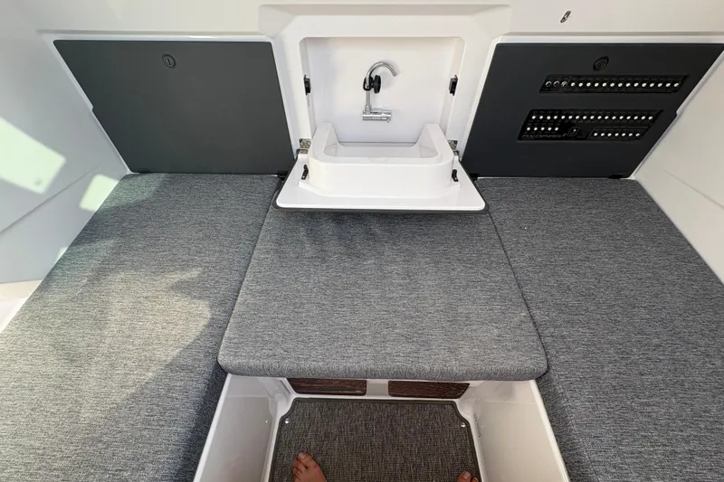 Slide: The Image of 2025 Axopar 29 XC Cross Cabin interior with compact sink and control panel. - 23