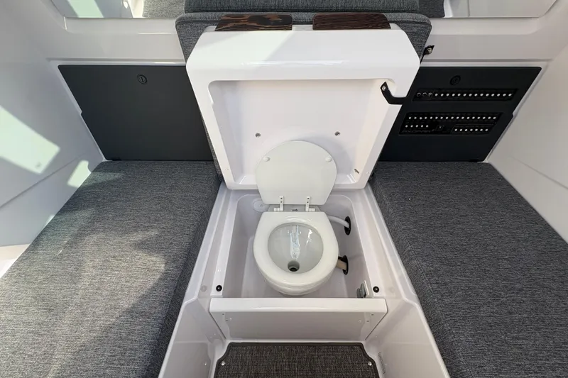 Slide: The Image of 2025 Axopar 29 XC Cross Cabin interior with hidden toilet feature. - 24