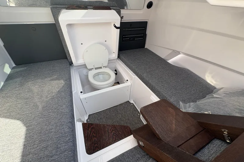 Slide: The Image of 2025 Axopar 29 XC Cross Cabin interior with hidden toilet feature. - 25