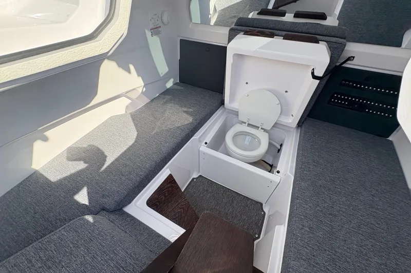Slide: The Image of 2025 Axopar 29 XC Cross Cabin interior with hidden toilet feature. - 26
