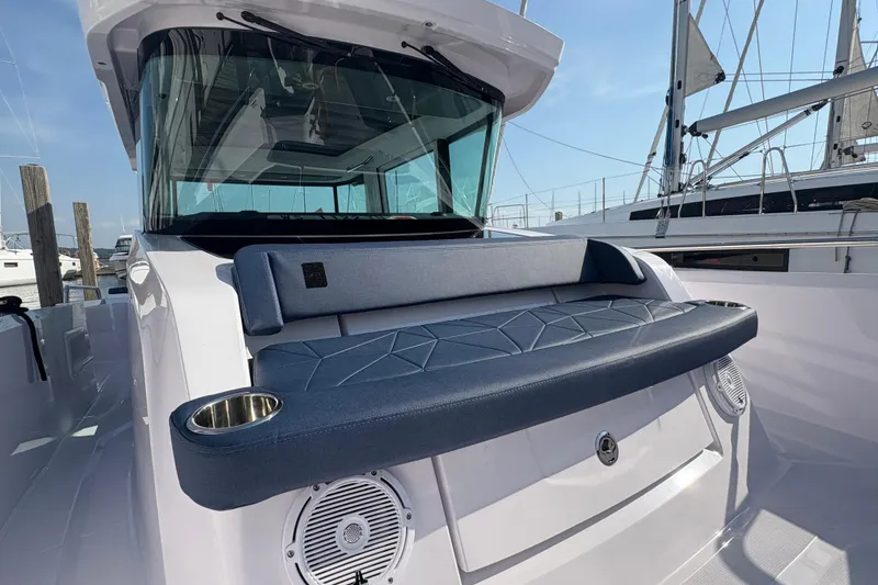 Slide: The Image of 2025 Axopar 29 XC Cross Cabin boat with cushioned seating and cup holders. - 27