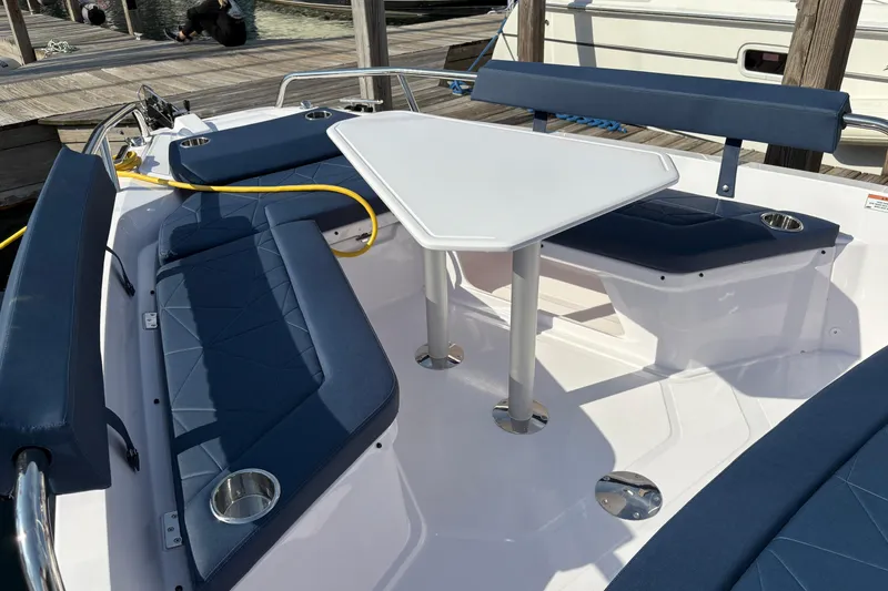 Slide: The Image of 2025 Axopar 29 XC Cross Cabin boat interior with blue seating and white table. - 28