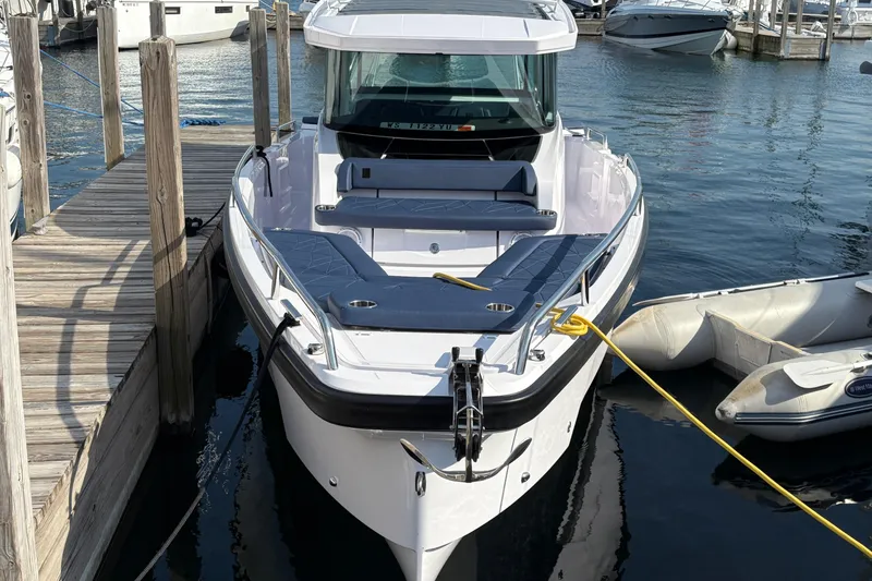 Slide: The Image of 2025 Axopar 29 XC Cross Cabin boat docked at marina. - 3