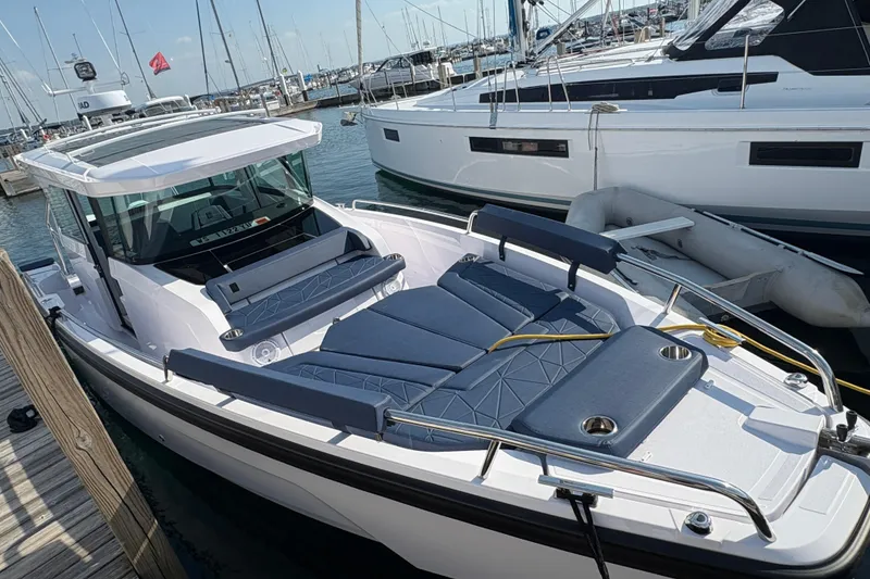 Slide: The Image of 2025 Axopar 29 XC Cross Cabin boat docked at marina, featuring sleek design and comfortable seating. - 34