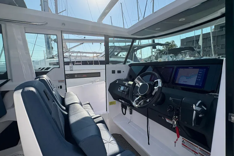Slide: The Image of 2025 Axopar 29 XC Cross Cabin interior with modern dashboard and seating. - 35