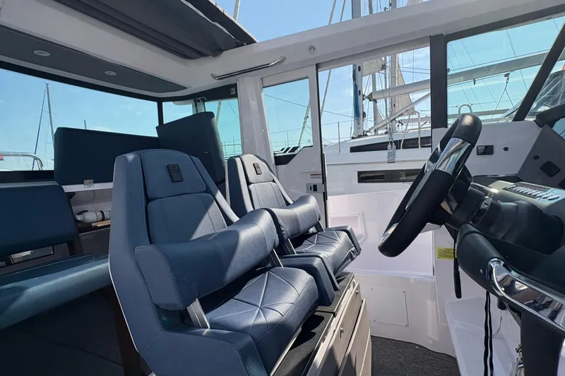 Slide: The Image of 2025 Axopar 29 XC Cross Cabin interior with modern seating and steering wheel. - 37