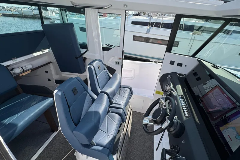 Slide: The Image of 2025 Axopar 29 XC Cross Cabin interior with modern helm and seating. - 38