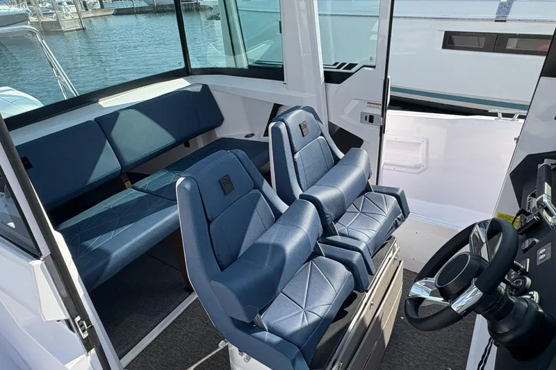 Slide: The Image of 2025 Axopar 29 XC Cross Cabin interior with blue seating and steering wheel. - 39