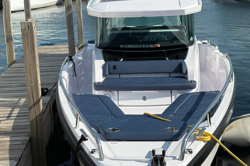 Slide: The Image of 2025 Axopar 29 XC Cross Cabin boat docked, featuring sleek design and comfortable seating. - 4