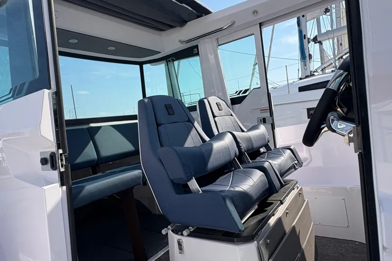 Slide: The Image of 2025 Axopar 29 XC Cross Cabin interior with modern seating and steering wheel. - 41