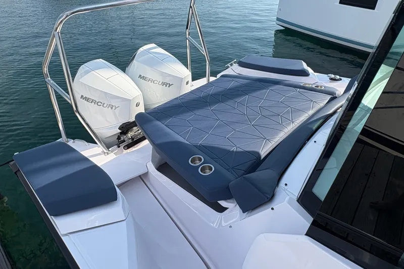 Slide: The Image of 2025 Axopar 29 XC Cross Cabin with dual Mercury engines and cushioned deck area. - 42