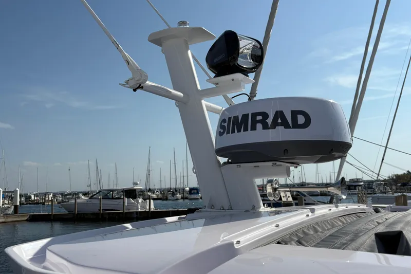 Slide: The Image of 2025 Axopar 29 XC Cross Cabin with Simrad radar at marina. - 43