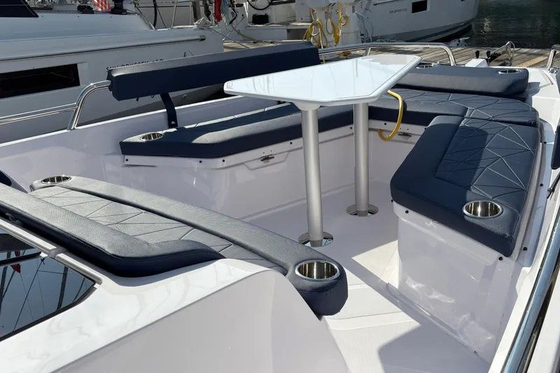 Slide: The Image of 2025 Axopar 29 XC Cross Cabin boat interior with sleek seating and modern table design. - 46