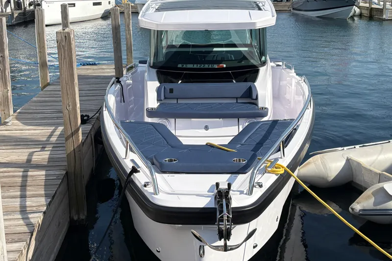 Slide: The Image of 2025 Axopar 29 XC Cross Cabin docked at marina, showcasing sleek design and modern features. - 5