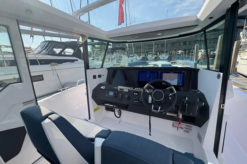 Slide: The Image of Interior view of 2025 Axopar 29 XC Cross Cabin boat, featuring modern dashboard and steering. - 51