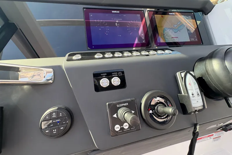 Slide: The Image of Control panel of 2025 Axopar 29 XC Cross Cabin with navigation screens and controls. - 54