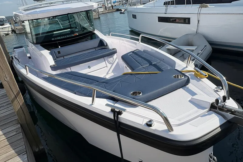 Slide: The Image of 2025 Axopar 29 XC Cross Cabin boat docked at marina, featuring sleek design and spacious seating. - 9
