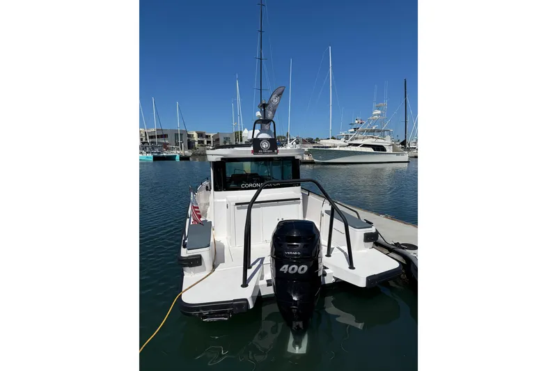 Slide: The Image of 2021 Axopar 28 Cabin BRABUS Trim Wet Bar docked in marina, rear view. - 3