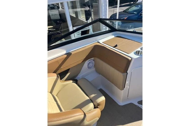 Slide: The Image of 2018 Sea Ray 21 SPX OB boat interior with tan seating and cup holders. - 12
