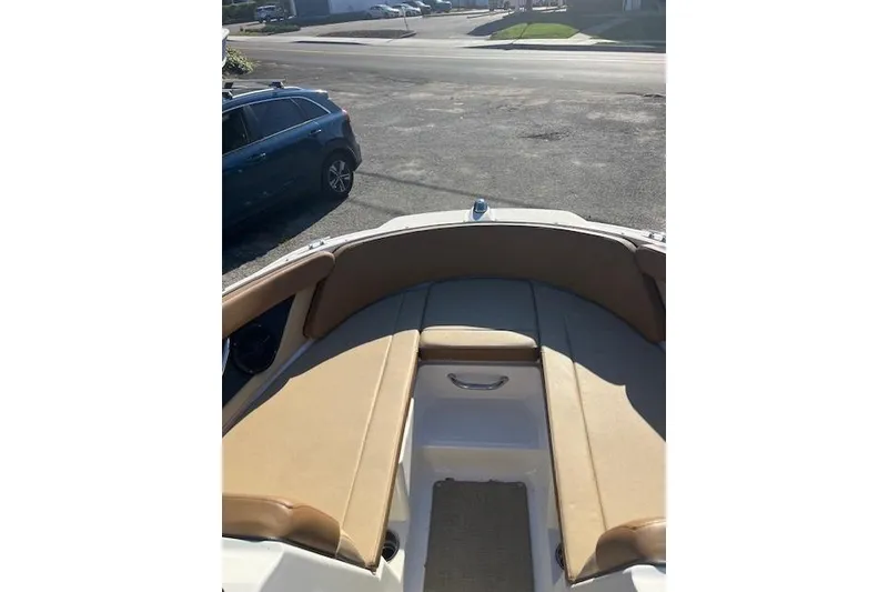 Slide: The Image of 2018 Sea Ray 21 SPX OB boat with tan seating, parked on a street. - 6