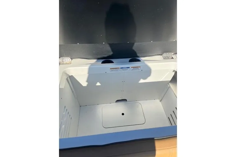 Slide: The Image of Open storage compartment in 2018 Sea Ray 21 SPX OB boat. - 9