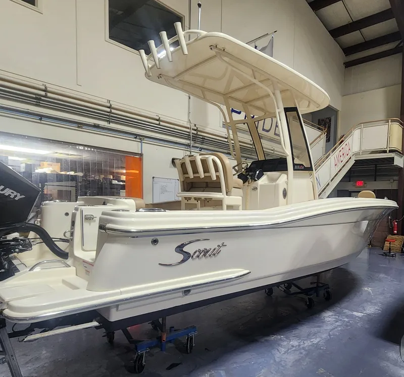 Slide: The Image of 2023 Scout 215 XSF boat in a workshop. - 10