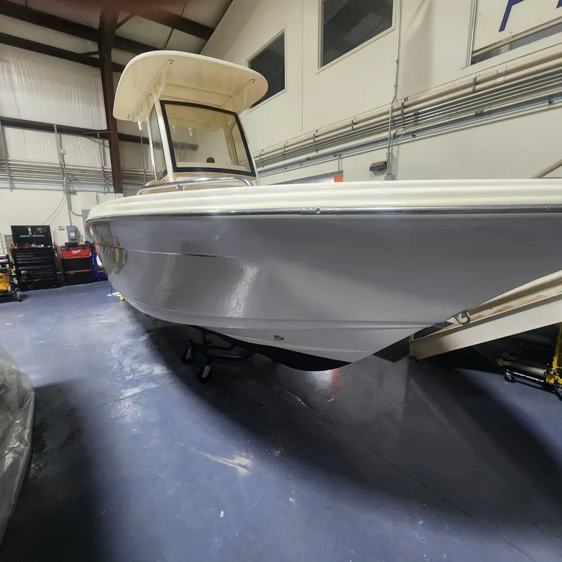 Slide: The Image of 2023 Scout 215 XSF boat in a workshop. - 11