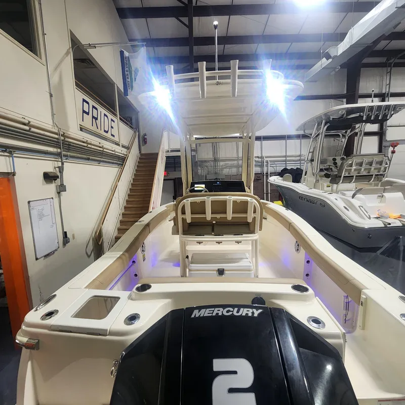 Slide: The Image of Scout 215 XSF 2023 boat with Mercury engine in a workshop. - 14