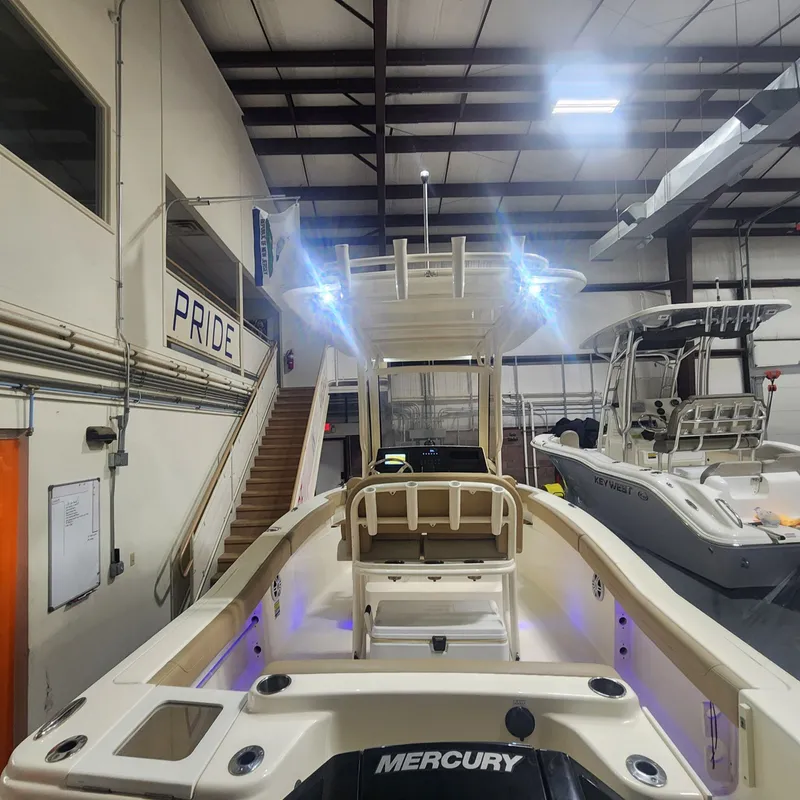 Slide: The Image of Scout 215 XSF 2023 boat in indoor storage with lighting. - 15