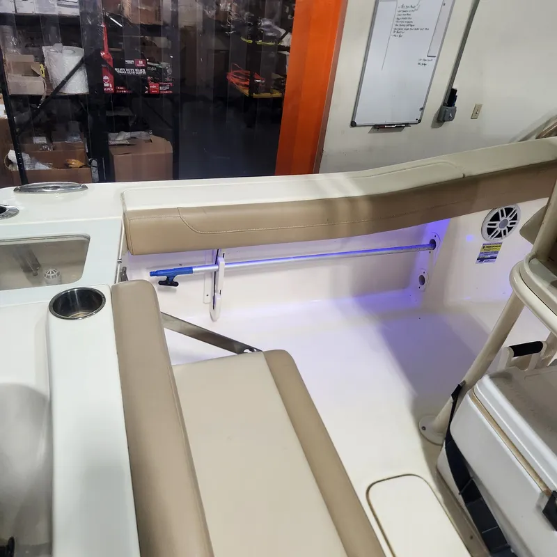Slide: The Image of Interior of a 2023 Scout 215 XSF boat with beige seating. - 16